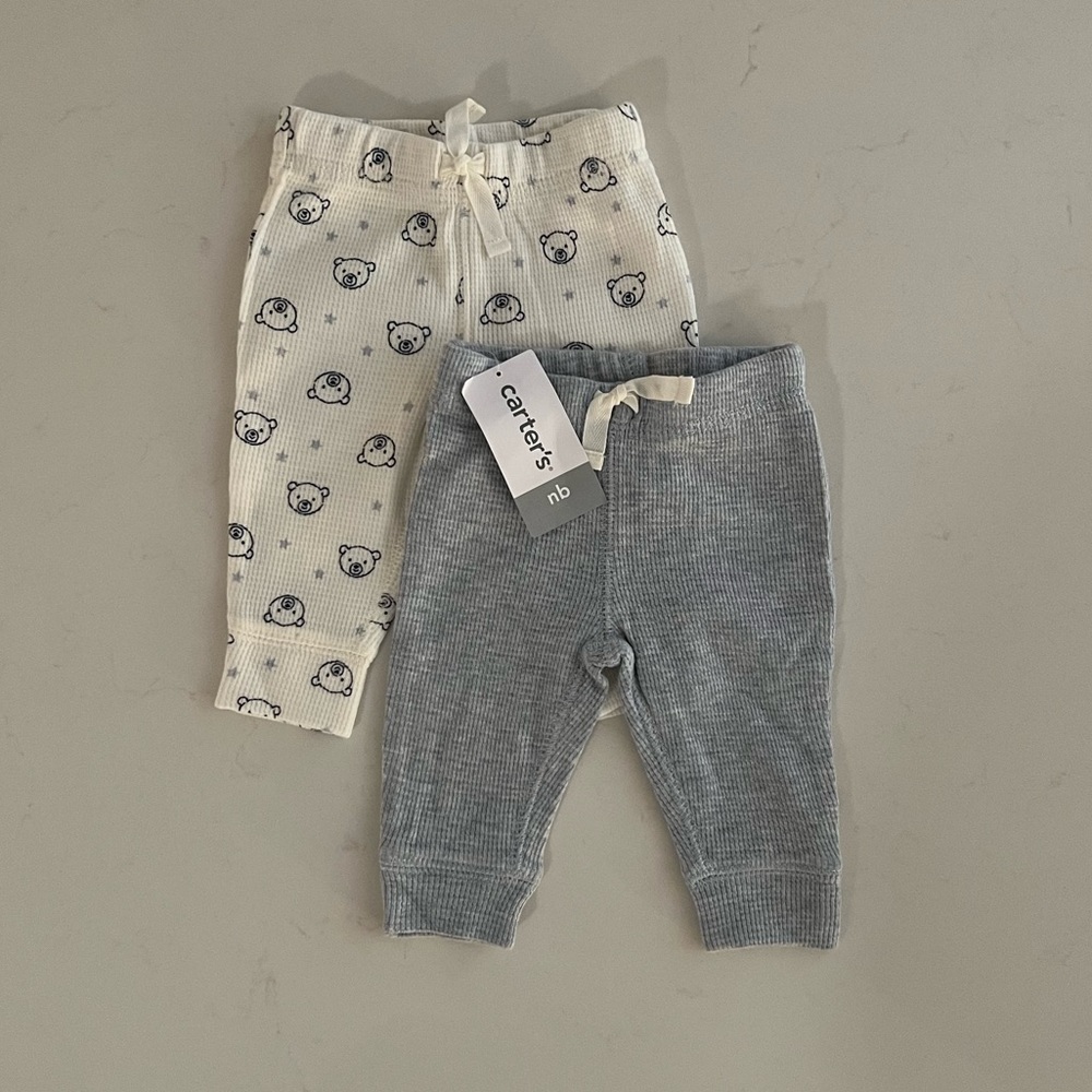 Carter’s Newborn Bottoms in light blue and white.